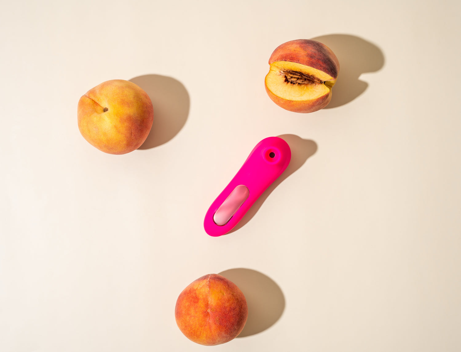 In a simple yet poignant setting, Peachii's "Little Pink" device is placed thoughtfully among ripe peaches, symbolizing the blend of natural indulgence and personal care that defines a relaxing afternoon.