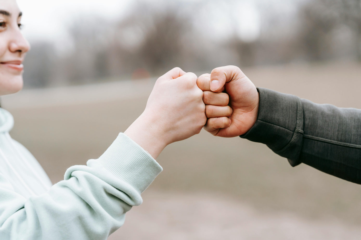 Peachii Help Program (PHP) exemplifies Peachii's commitment to giving back. By donating 5% of each purchase to various causes, they support empowering women in need, environmental conservation, developing women's sports, shaping the future, and supporting female entrepreneurs. This image of a fist bump represents unity and collaboration, symbolizing the positive impact of the PHP initiative.