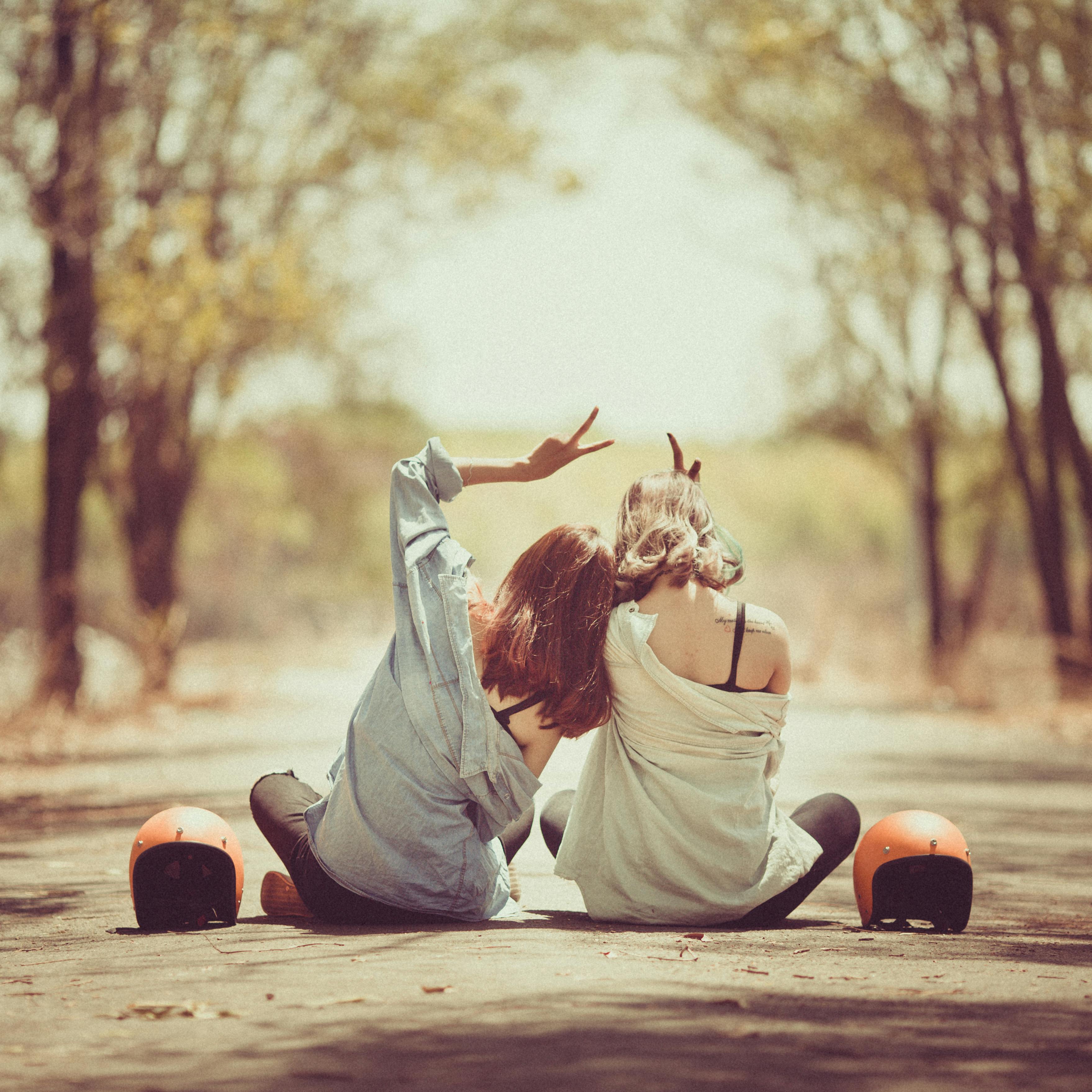 Two friends relax after a long skate, sharing a moment of joy and connection under the open sky, embodying the spirit of the Peachii Help Program. Through this initiative, Peachii is committed to philanthropy, dedicating a portion of every purchase to empower women, conserve the environment, and support women's sports and female entrepreneurs, making a meaningful impact in the community and on our planet.